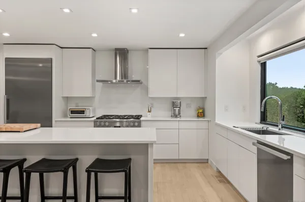a kitchen with stainless steel appliances granite countertop a sink and cabinets