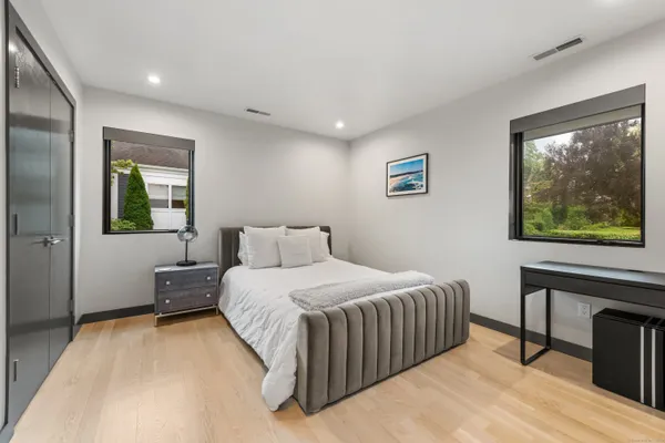 a bedroom with a bed and a painting on the wall
