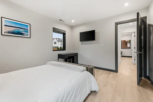 a bedroom with a bed and a flat screen tv