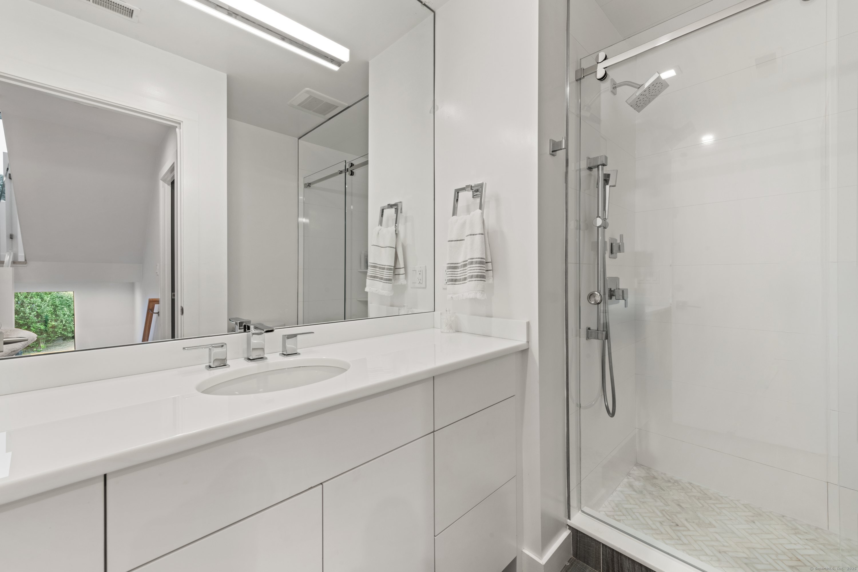 200 Hillspoint Road Westport, CT 06880 - Photo 23 of 37 a bathroom with a shower sink and mirror