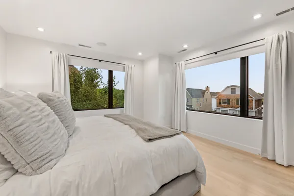 a bedroom with a large bed and a large window