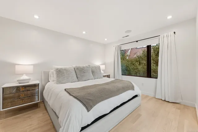 a large bedroom with a large bed and a large window