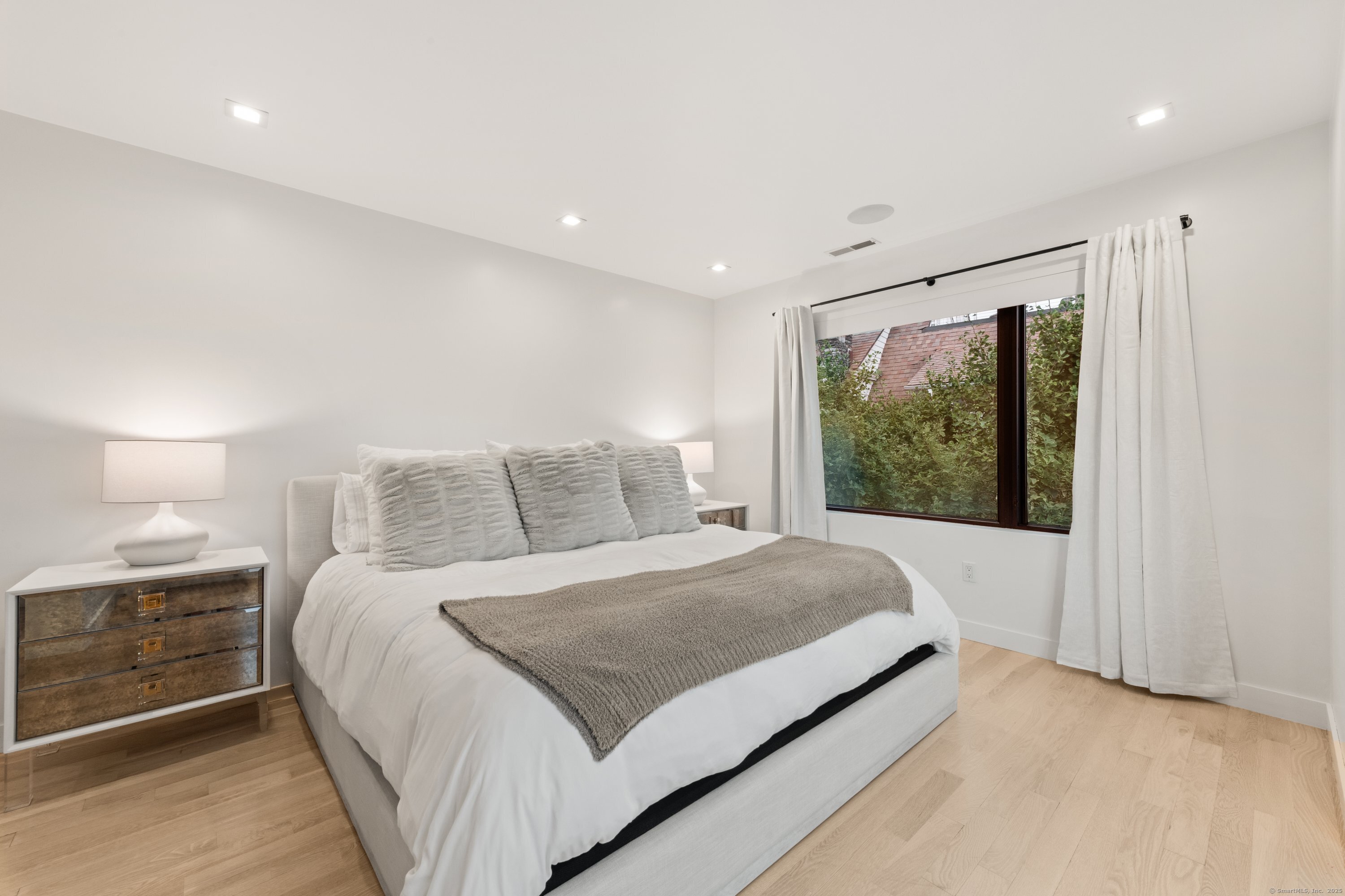 200 Hillspoint Road Westport, CT 06880 - Photo 25 of 37 a large bedroom with a large bed and a large window