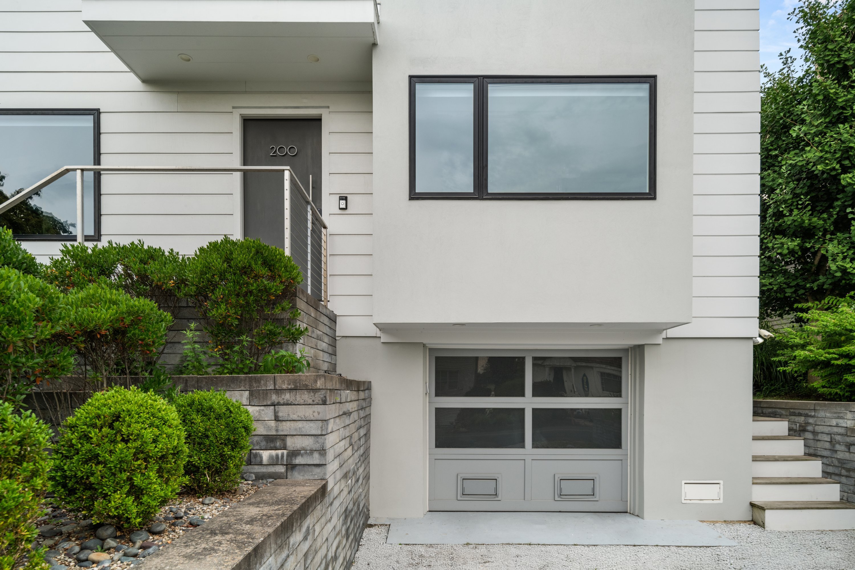 200 Hillspoint Road Westport, CT 06880 - Photo 3 of 37 a front view of a house with a yard