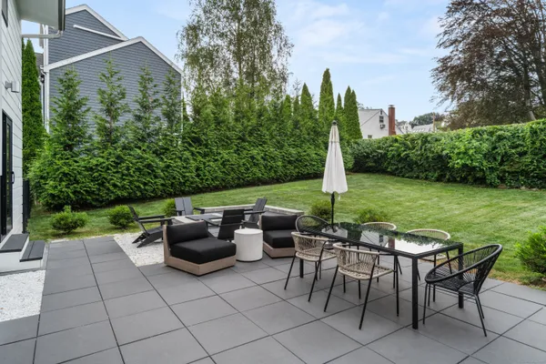 a view of a backyard with sitting area