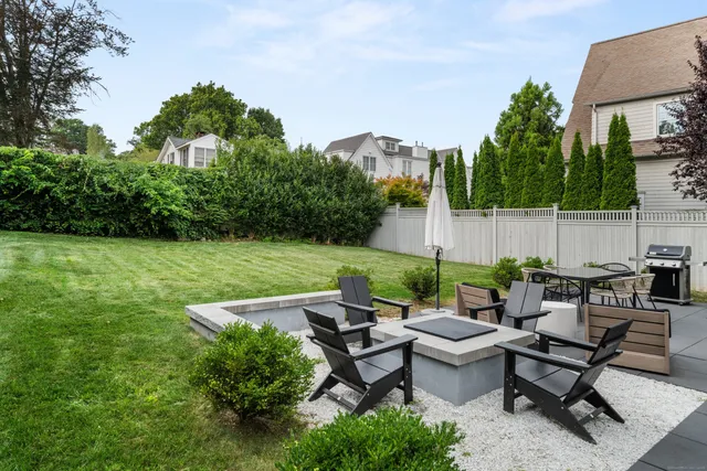 a view of a house with backyard and sitting area