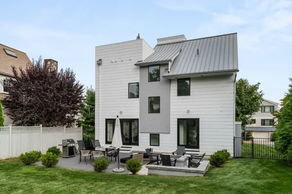 a view of a house with backyard and sitting area