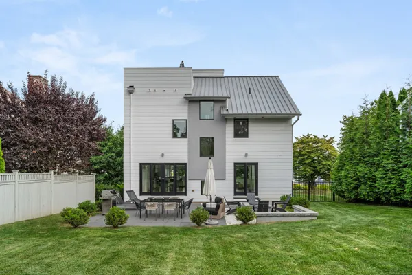 a view of a house with backyard and sitting area