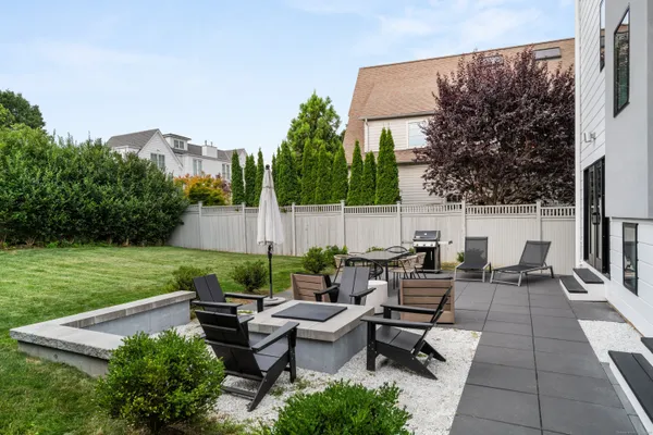 a view of a patio with couches and a table and chairs with garden view