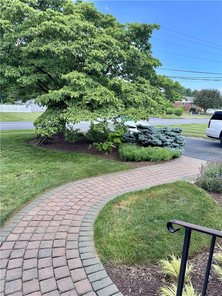 5334 Egypt Road Laurys Station, PA 18059 - Photo 40 of 55 A graceful paved pathway winds through a meticulously kept landscape, leading to a charming home entrance.