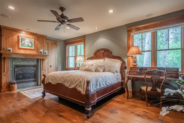 a spacious bedroom with a bed and a fireplace