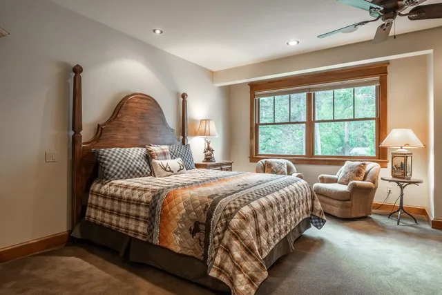 a bedroom with bed chair and window