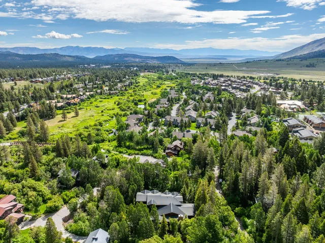 an aerial view of a house with a yard and swimming pool