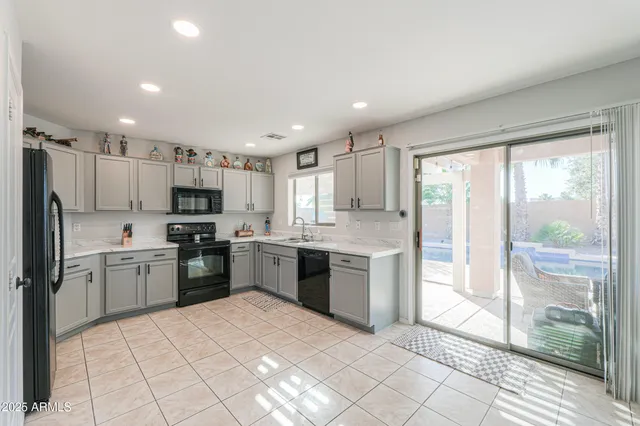 a large kitchen with a large window and stainless steel appliances