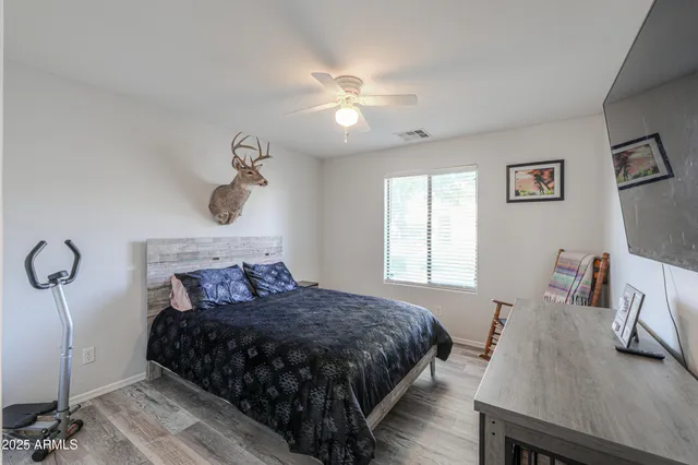 a bedroom with a bed and a chandelier