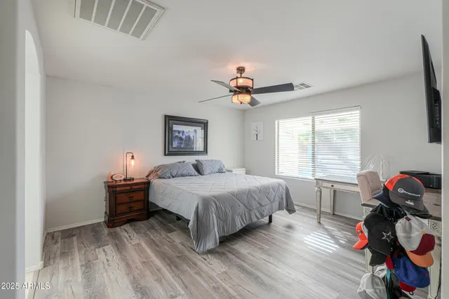 a bedroom with a bed and a chandelier