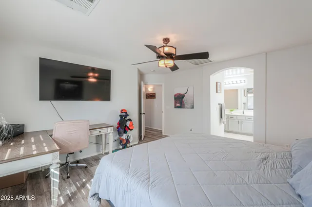 a bedroom with a bed and a flat screen tv