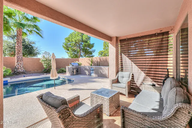 swimming pool view with a seating space