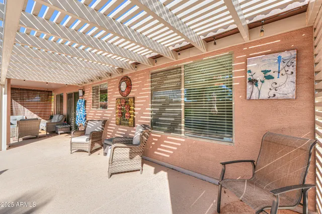 a view of a patio with a table and chairs and potted plants
