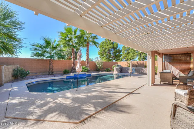 a view of swimming pool with outdoor seating and plants