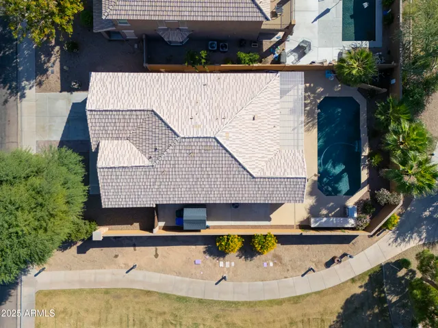 a view of a house with pool and chairs