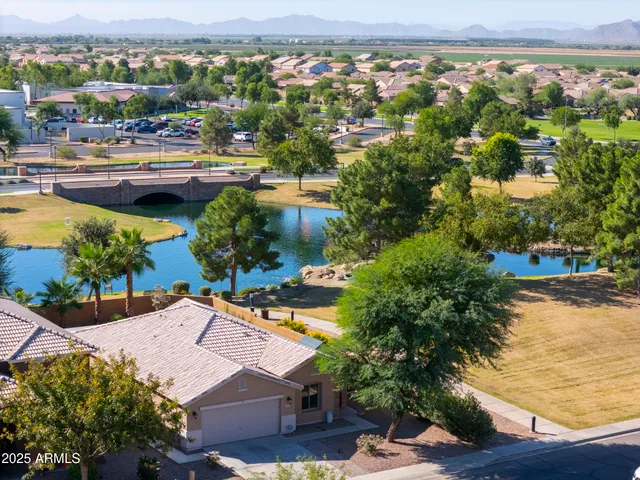 an aerial view of residential houses and lake view