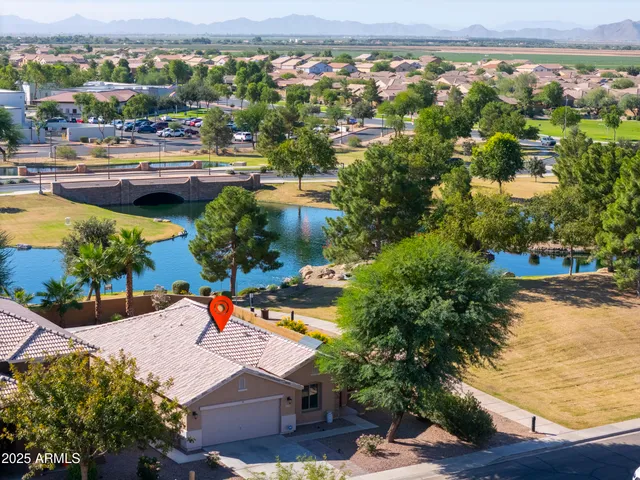 an aerial view of residential houses with outdoor space and swimming pool