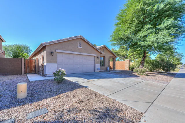 a front view of a house with a yard and trees