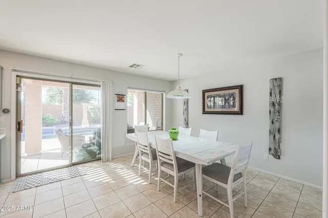 a view of a dining room with furniture and a potted plant