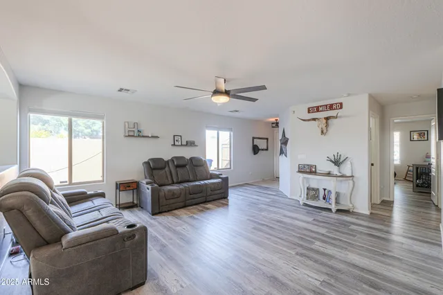 a living room with furniture and a wooden floor