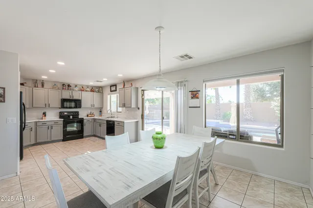 a large kitchen with a table and chairs