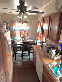 a kitchen with sink stove and cabinets