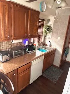 a kitchen with a sink window and cabinets