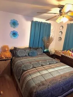 a bedroom with a bed and a painting on the wall