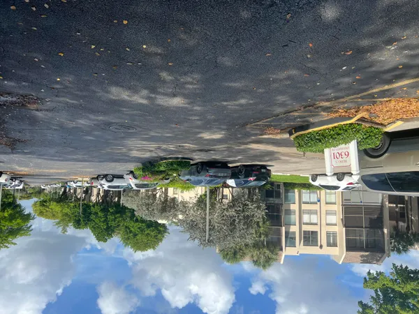a view of a patio with table and chairs under an umbrella