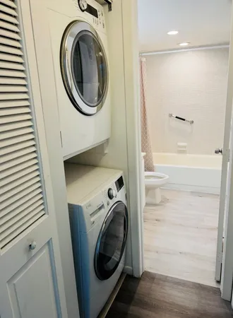 a view of a hallway with washer and dryer