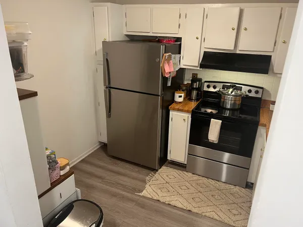 a kitchen with appliances and cabinets