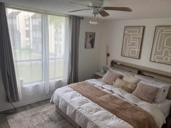 a bedroom with a large bed and a window