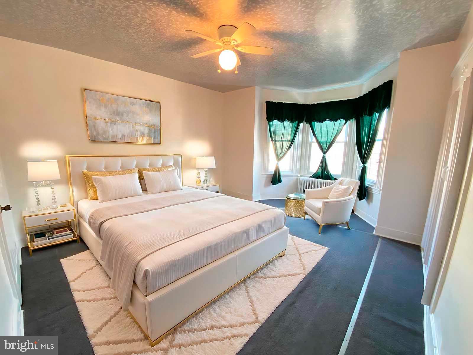 538 West Pike Street Philadelphia, PA 19140 - Photo 12 of 34 a bedroom with a large bed and a chandelier