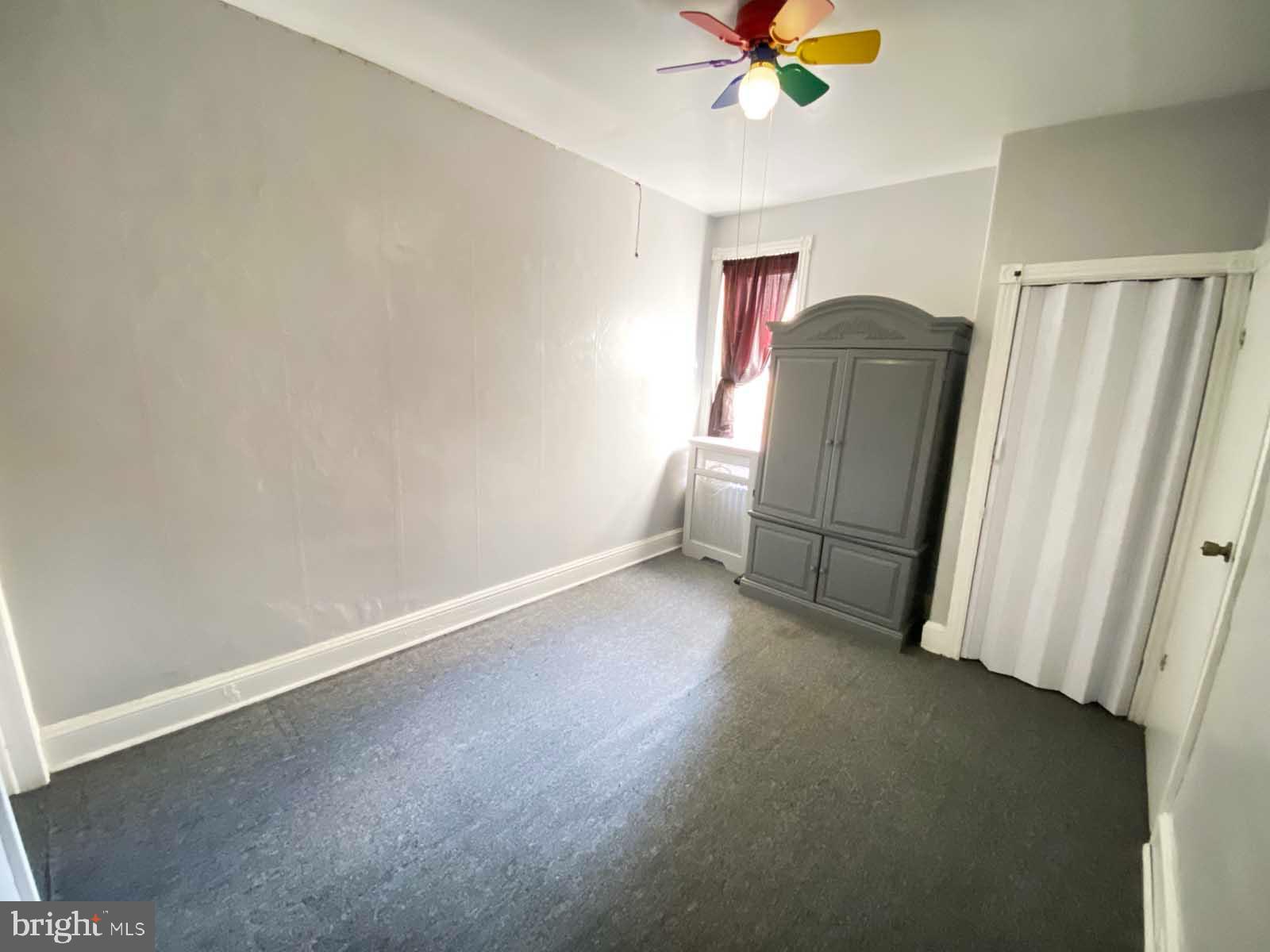 538 West Pike Street Philadelphia, PA 19140 - Photo 16 of 34 an empty room with a window and a ceiling fan