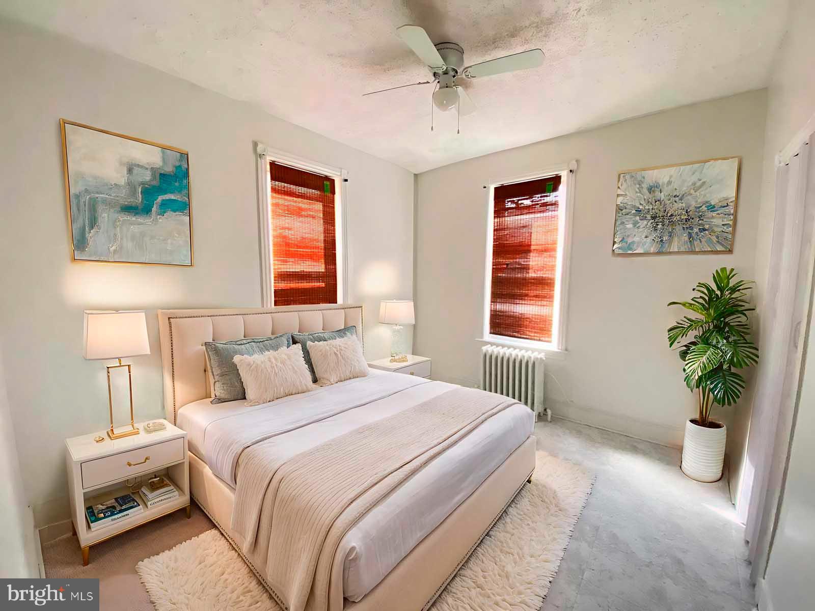 538 West Pike Street Philadelphia, PA 19140 - Photo 20 of 34 a bedroom with a bed and a potted plant