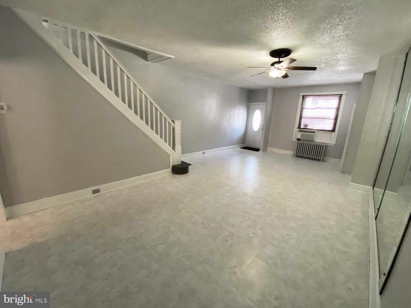 538 West Pike Street Philadelphia, PA 19140 - Photo 6 of 34 a view of an empty room with stairs and a chandelier fan