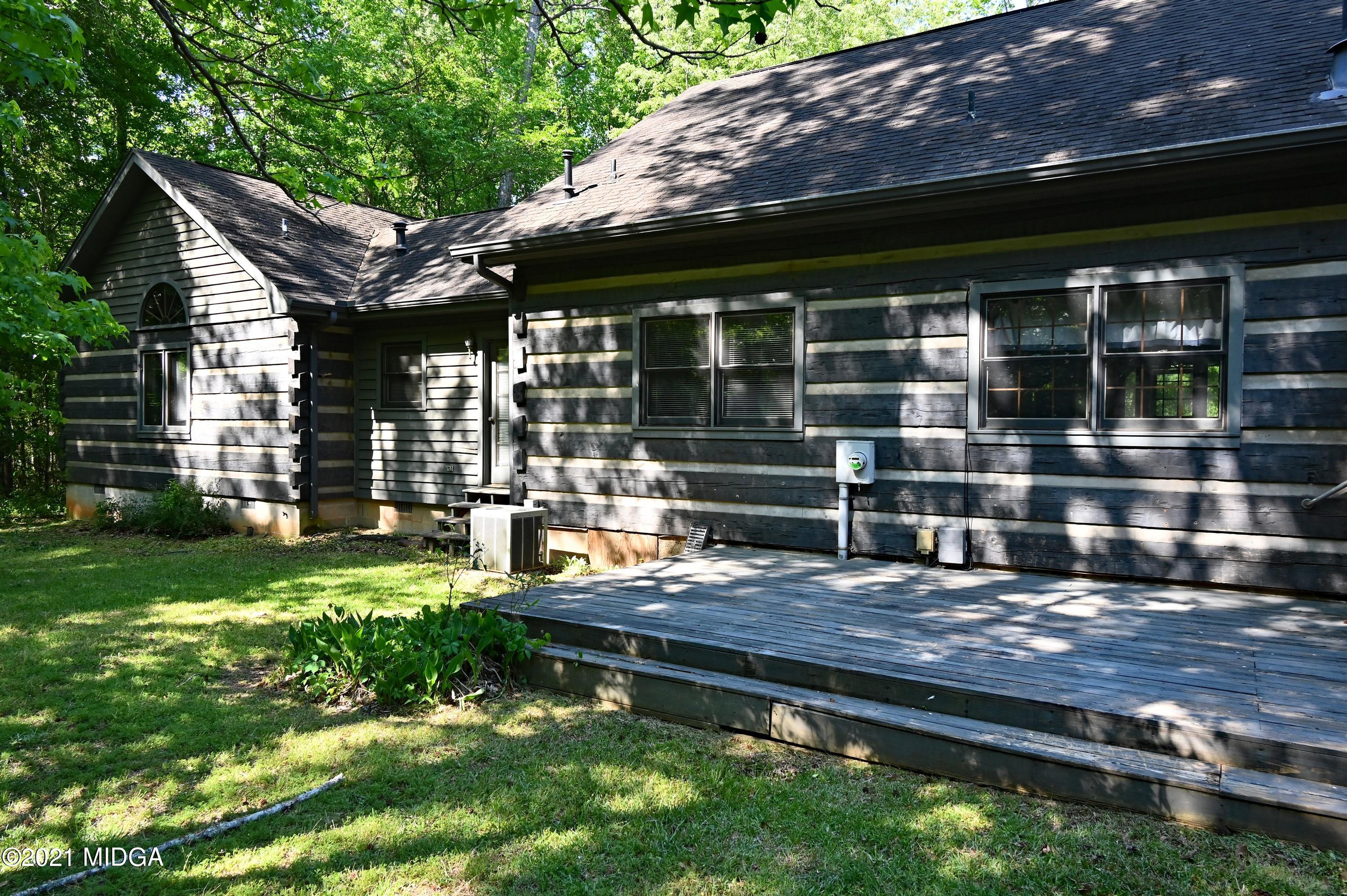 10333 Estes Road Macon, GA 31210 - Photo 19 of 29 a wooden bench sitting in front of a house