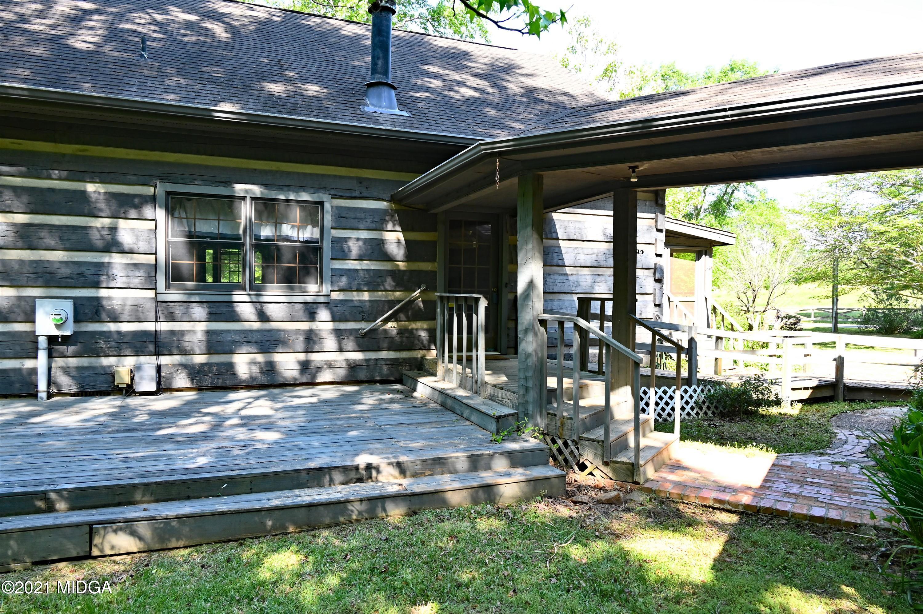 10333 Estes Road Macon, GA 31210 - Photo 22 of 29 a view of a two chair under an umbrella