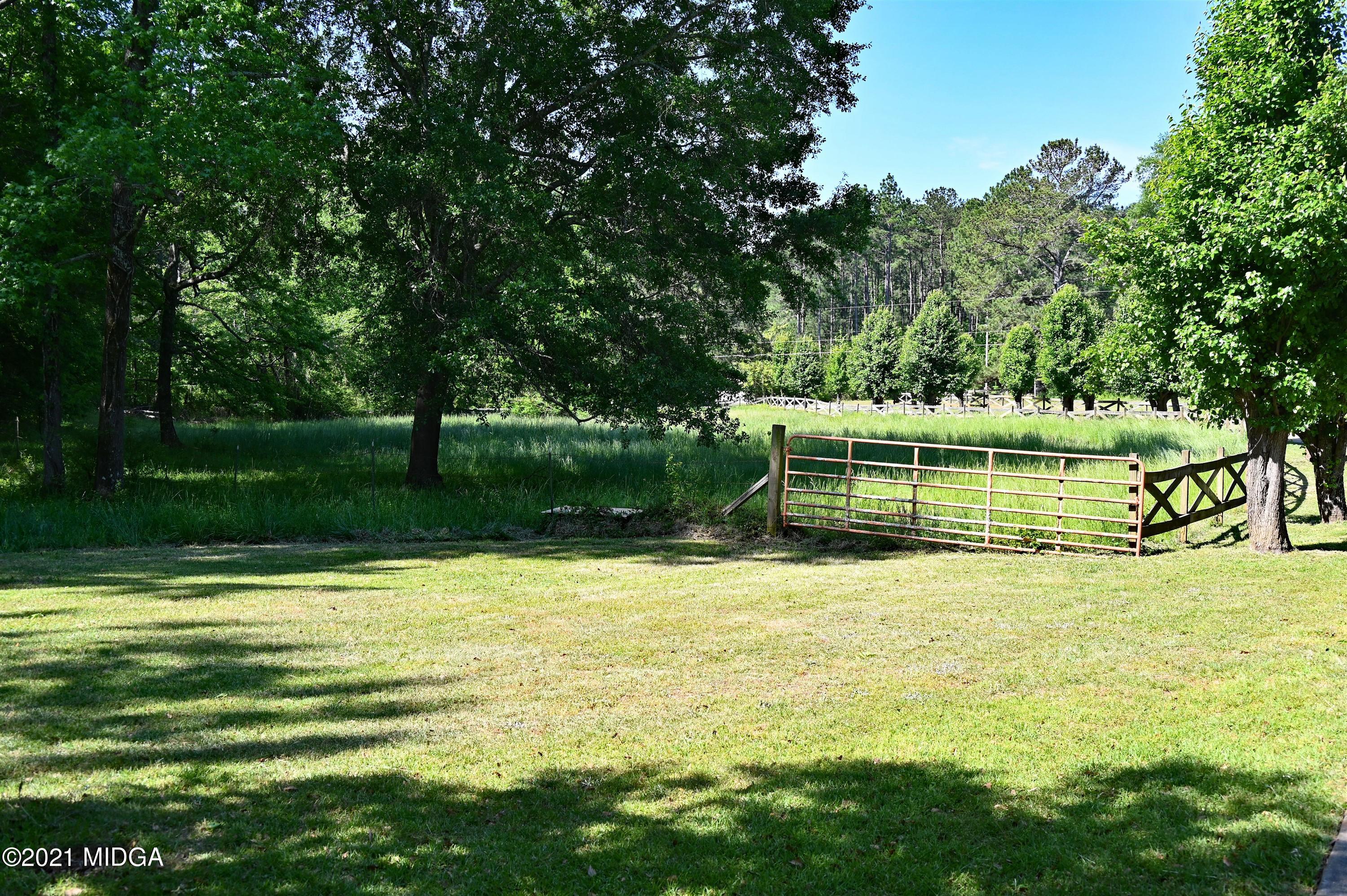 10333 Estes Road Macon, GA 31210 - Photo 24 of 29 a view of a swimming pool with a garden