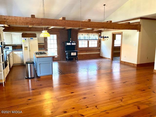 10333 Estes Road Macon, GA 31210 - Photo 4 of 29 a view of a living room with kitchen island wooden floor and flat screen tv