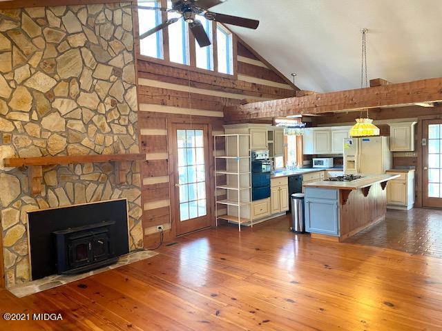 10333 Estes Road Macon, GA 31210 - Photo 5 of 29 a living room with stainless steel appliances kitchen island granite countertop a stove top oven a sink and a wooden floor