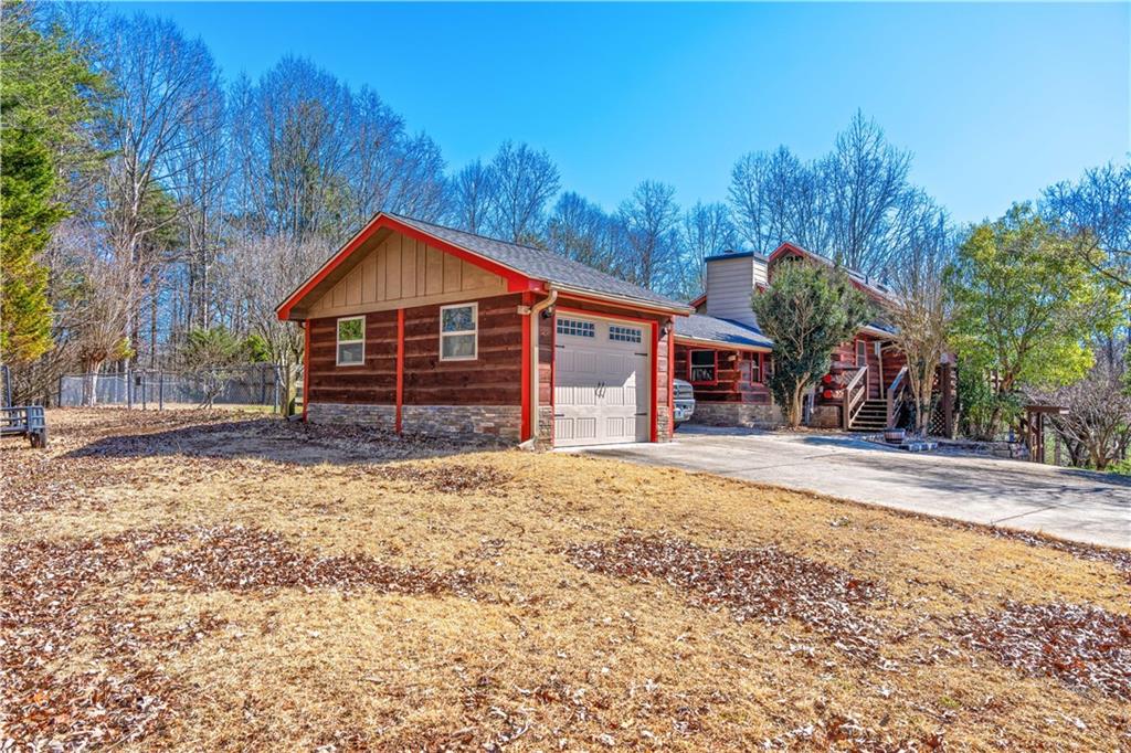 110 Rathgeb Trail Jasper, GA 30143 - Photo 19 of 62 a front view of a house with a yard and garage