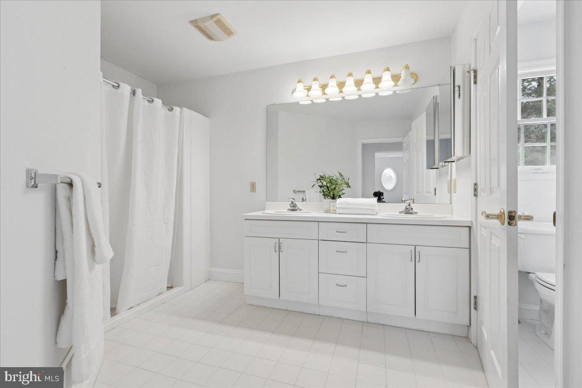 45 Hedge Row Road Princeton, NJ 08540 - Photo 23 of 29 a bathroom with a sink vanity and a mirror