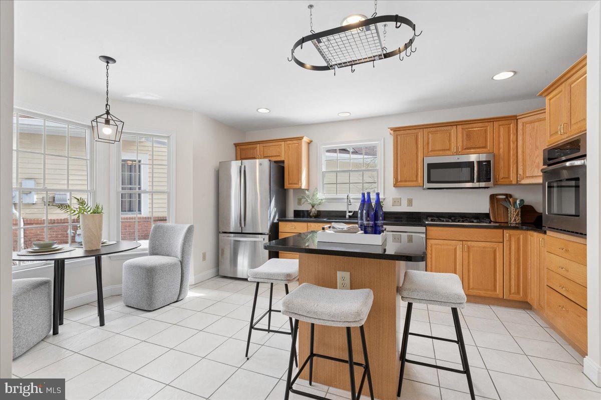 45 Hedge Row Road Princeton, NJ 08540 - Photo 5 of 29 a kitchen with stainless steel appliances granite countertop a stove top oven a sink dishwasher a dining table and chairs with wooden floor